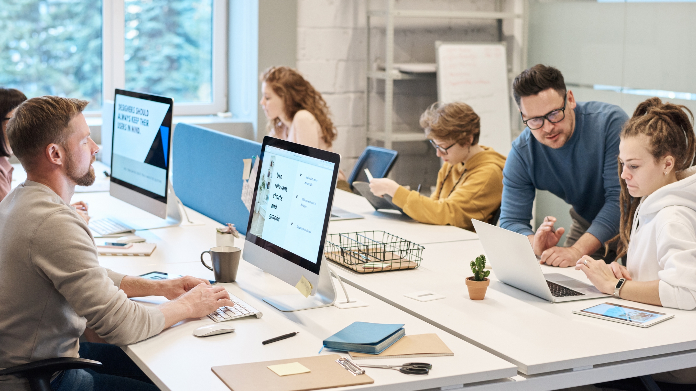 People working in front of the computer⁠ with robust pc setup thanks to IT support